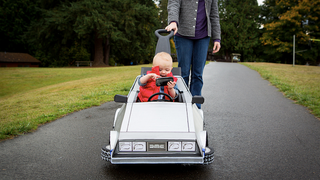 Illustration for article titled This Awesome Baby's Marty McFly Costume and DeLorean Push Car Is Absolutely Adorable